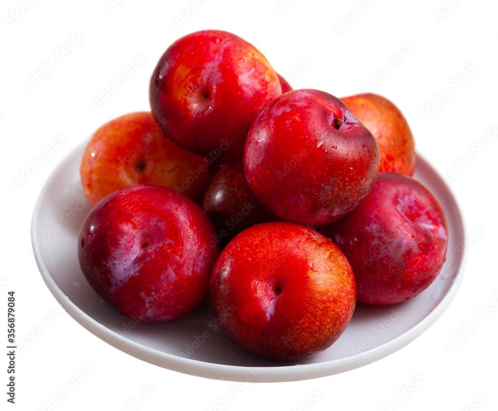 Fresh red plums in plate