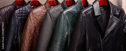 New collection of different color spring leather jackets for men. Colorful background of modern outerwear.