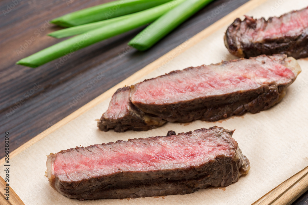 Fresh grilled meat. Grilled marbled beef steak medium rare on wooden cutting board Fresh grilled meat. Grilled marbled beef steak medium rare on wooden cutting board