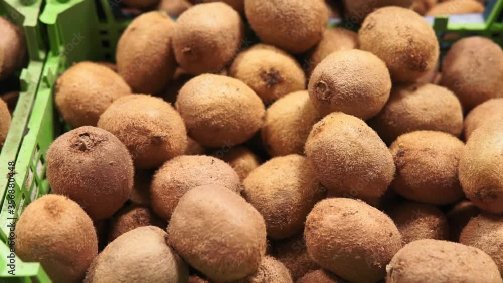 Ripe kiwi in the market. A lot of juicy fruit. vitamins and healthy diet. Selling in the market, fruit shop Ripe kiwi in the market. A lot of juicy fruit. vitamins and healthy diet. Selling in the market, fruit shop