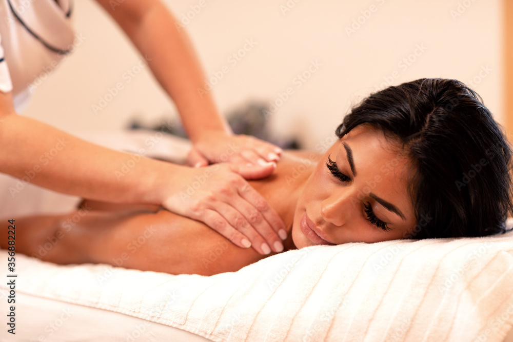 Fototapeta premium Tanned sexy woman enjoying her massage