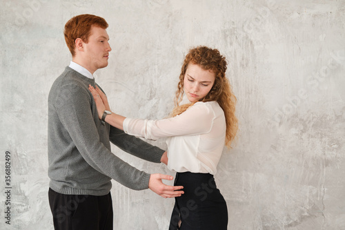 Bild auf Leinwand Unhappy young couple arguing, offended affronted woman pushing man staying her back husband wants to apologize to frustrated wife, family conflict at home, bad marriage relationships concept