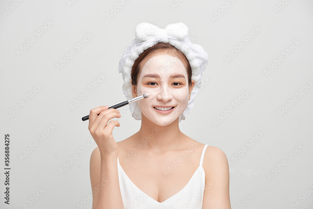 Spa Asian woman applying facial clay mask. Spa beauty concept. Spa Asian woman applying facial clay mask. Spa beauty concept.