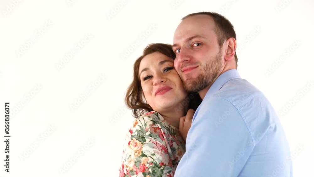 Young couple hugging each other, smiling at camera Young couple hugging each other, smiling at camera