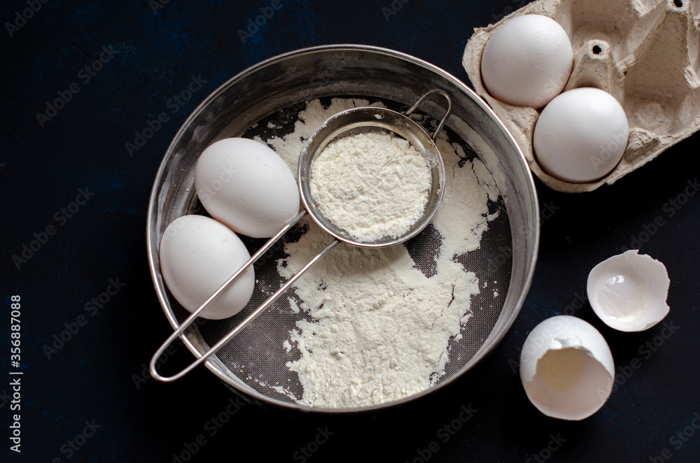 ingredients for cookies. cookie cutters on a dark background with flour and a rolling pin ingredients for cookies. cookie cutters on a dark background with flour and a rolling pin