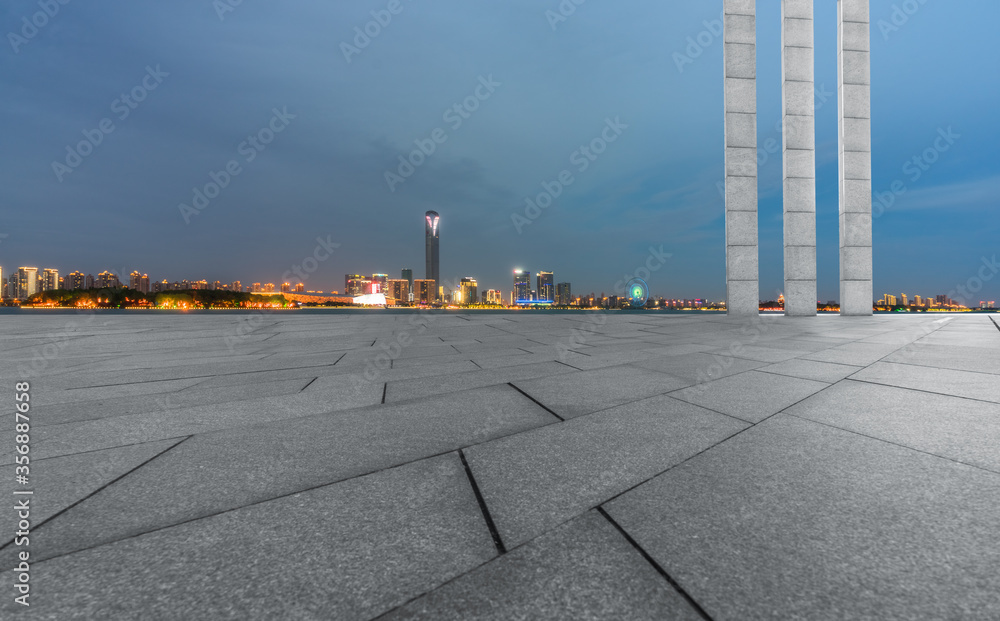 night view of empty brick floor front of modern building night view of empty brick floor front of modern building