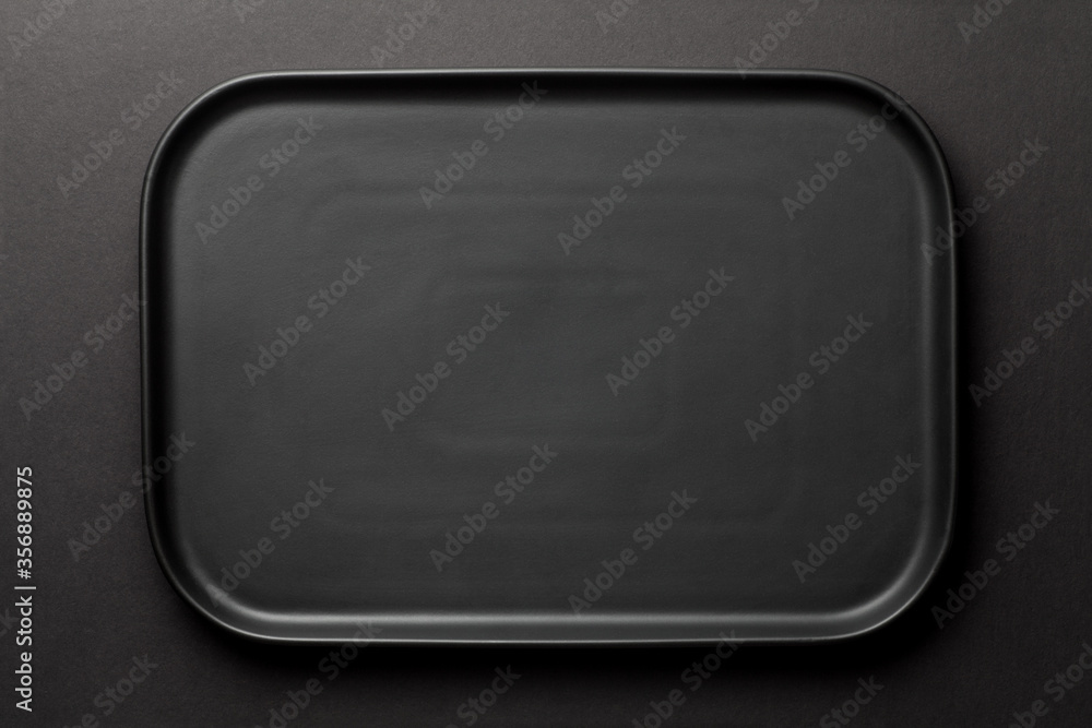 Top view of empty black plate on black background Top view of empty black plate on black background