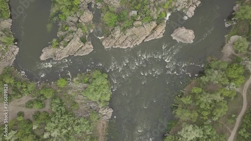 Aerial view to granite mountains and rapids on Southern Bug river, surrounded by trees and grasses, Mihiia village. Ukraine. Famous place for rafting and kayaking photo