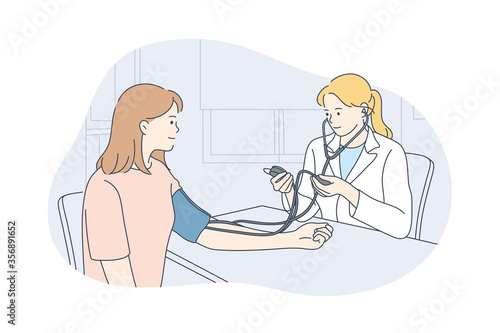 Healthcare, examination, medicine concept. Young happy woman doctor physician medical worker cartoon character talks with girl patient measuring heart rate at hospital. Health checkup and medical care