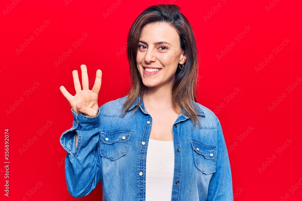 Young beautiful woman wearing casual clothes showing and pointing up with fingers number four while smiling confident and happy. Young beautiful woman wearing casual clothes showing and pointing up with fingers number four while smiling confident and happy.
