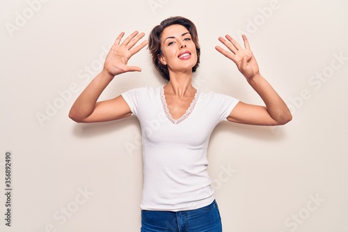 Young beautiful woman wearing casual clothes showing and pointing up with fingers number nine while smiling confident and happy.