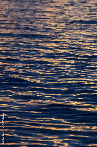 sea wave close up, low angle view. reflection of sun lights