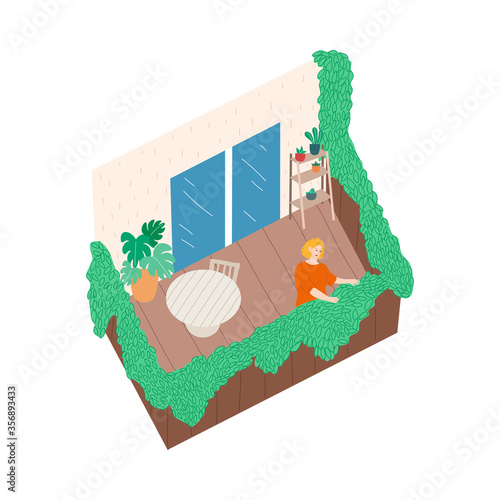 Smiling woman standing on balcony and touching green blooming plant