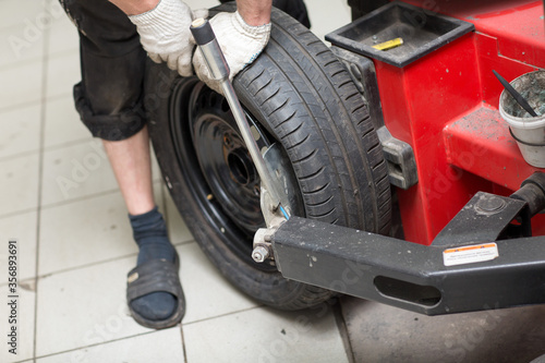 Mechanic changing car tire fitting. Wheel tyre repairing.