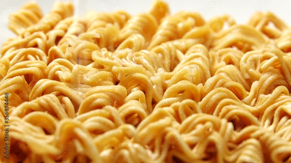 Close-up Dry instant noodles of tasty instant staple food block hot water 4K UltraHD tilting footage Close-up Dry instant noodles of tasty instant staple food block hot water 4K UltraHD tilting footage