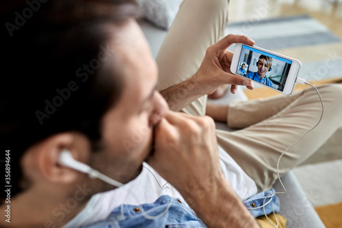 Close-up of a sick man having video call with a doctor from home.