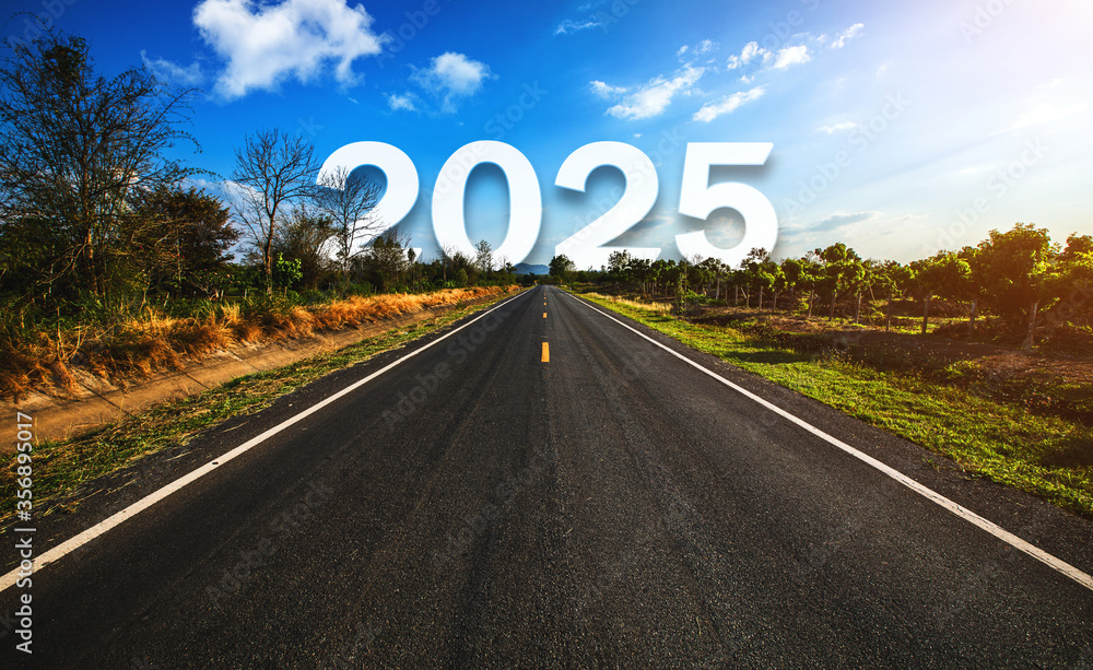 The word 2025 behind the tree of empty asphalt road at golden sunset and beautiful blue sky