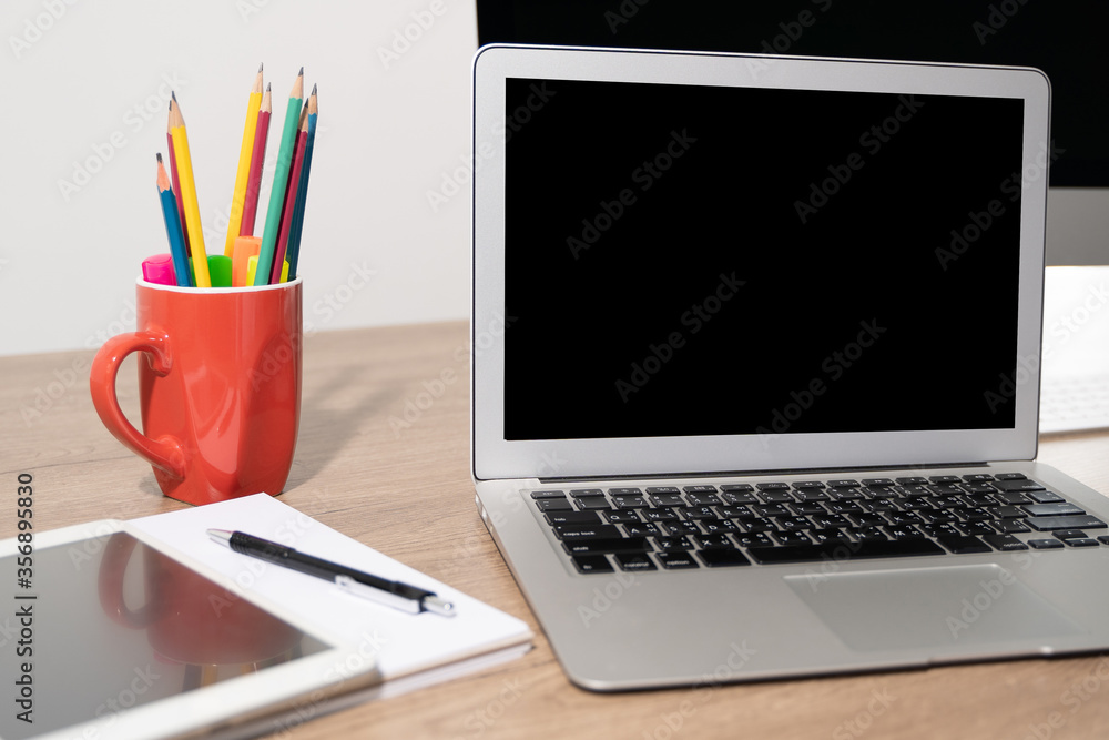 Laptop with blank screen on table. Workspace background new project on laptop computer with blank copy space screen for your advertising text message Laptop with blank screen on table. Workspace background new project on laptop computer with blank copy space screen for your advertising text message