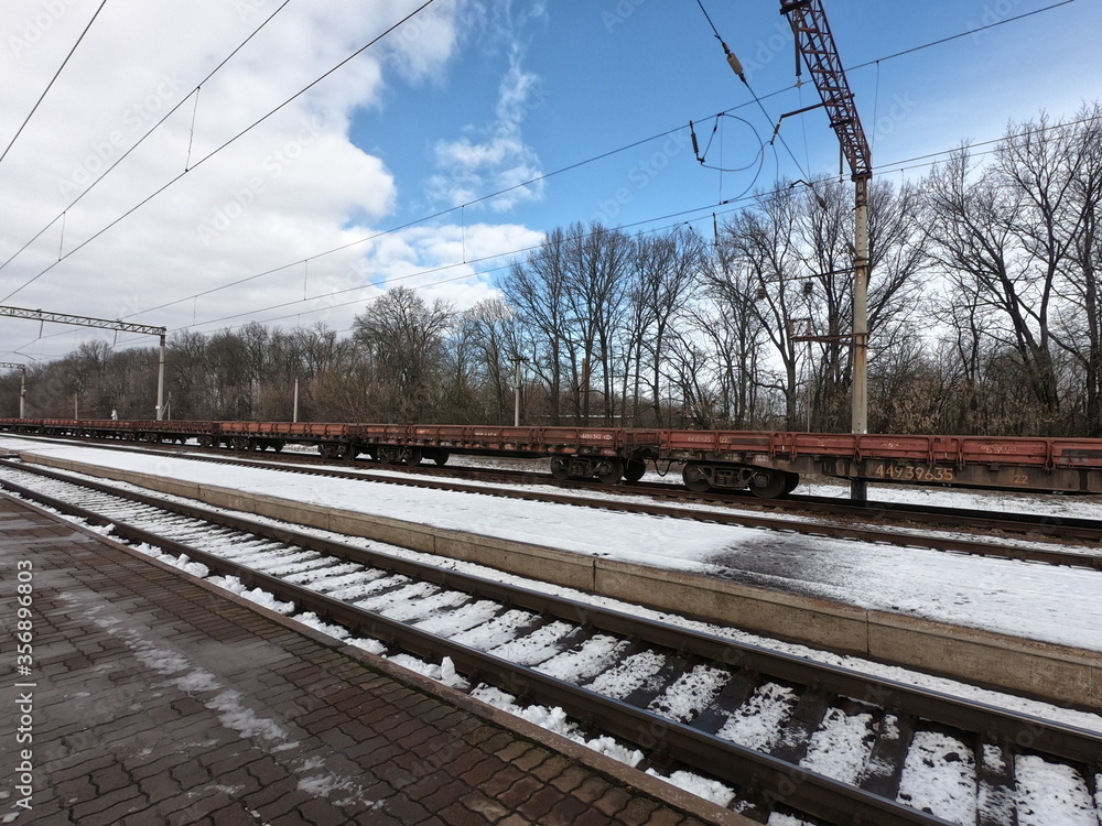 Railway freight platforms at the station on a sunny winter day.