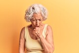 Senior grey-haired woman wearing casual clothes feeling unwell and coughing as symptom for cold or bronchitis. health care concept.