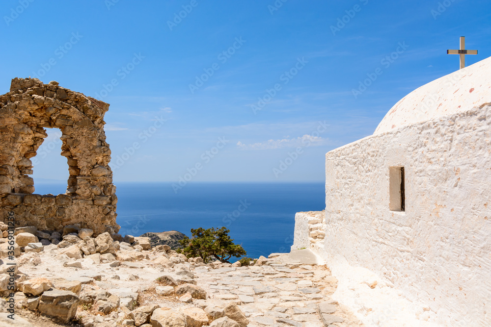 White chapel and old ruins on the hill of Monolithos castle on Rhodes island. Greece
