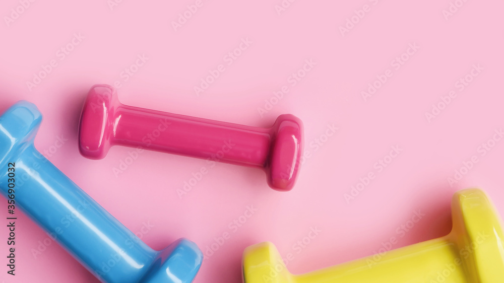 close up of dumbbell on pink background close up of dumbbell on pink background