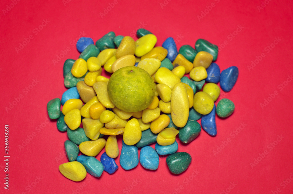 Yellow Lemon on multicolor pebbles Yellow Lemon on multicolor pebbles