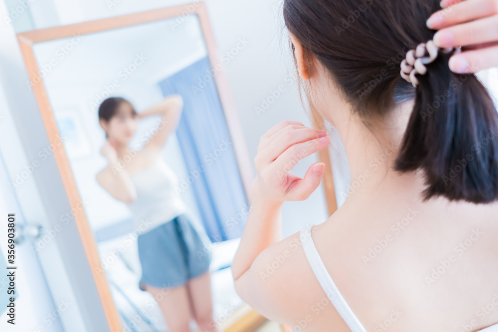 Asian beauty young woman her looking front mirror with clothes fashion