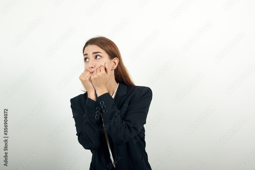 Image of scared, biting fists emotionally. Covering mouth behind knuckle. Having fear. Nervous frightened keeps hand near face, worried expression. Anxious unshaven feels depressed. Attractive woman Image of scared, biting fists emotionally. Covering mouth behind knuckle. Having fear. Nervous frightened keeps hand near face, worried expression. Anxious unshaven feels depressed. Attractive woman