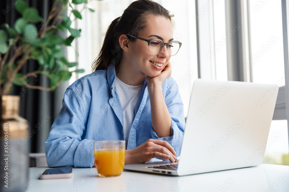 Attractive young woman sitting at the kitchen table Attractive young woman sitting at the kitchen table