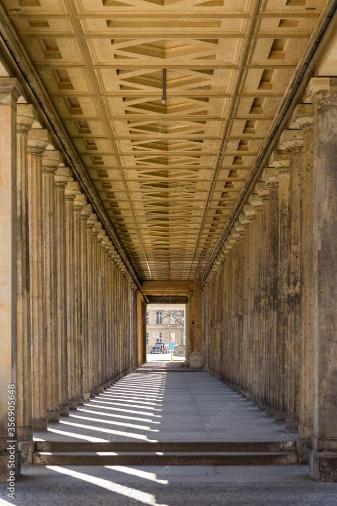 Vertical view of long empty gallery corridor of the Neue Nationalgalerie (New National Gallery). Portico with columns in perspective, in the Museum Island, Berlin, Germany