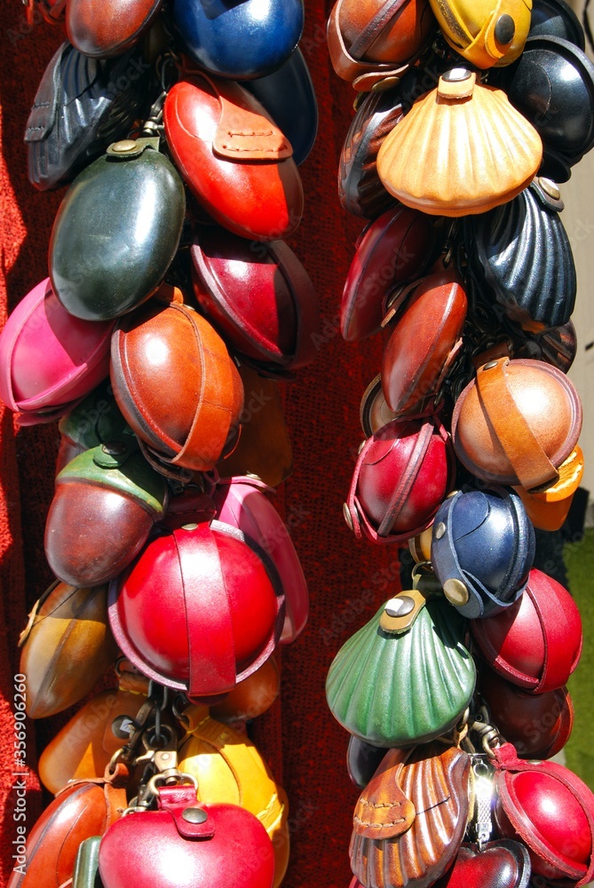 Colourful leather purses for sale outside a shop in the village centre, Frigiliana, Andalusia, Spain.