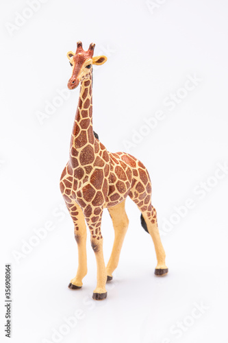 close up of a giraffe from a plastic toy isolated on a white background