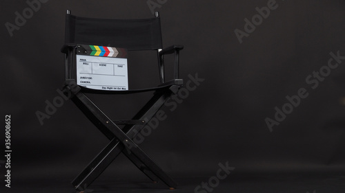 Director chair and Clapper board or movie slate and use in video production and cinema industry.It is put on black background.