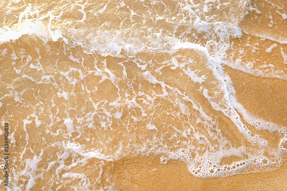 motion blurred wave coming on sandy beach motion blurred wave coming on sandy beach