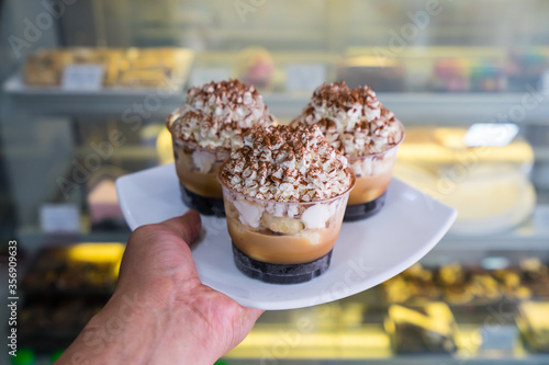 Banoffee cake cup  on hand in shop photo