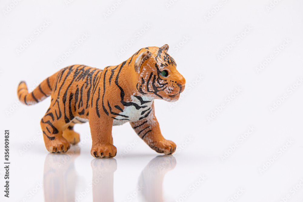 close up of a baby tiger from a plastic toy isolated on a white background close up of a baby tiger from a plastic toy isolated on a white background