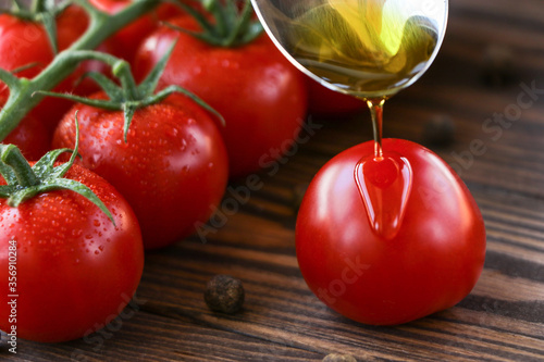 olive oil is poured onto a tomato