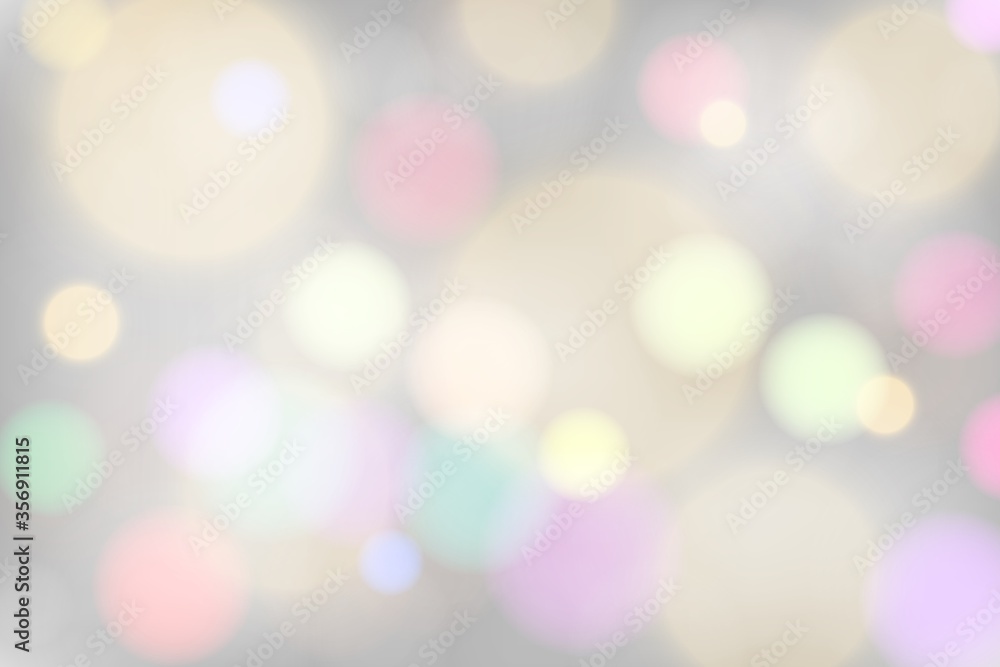 Silver festive background with colorful bokeh. Christmas glowing lights different colors. Holiday decorative effect.