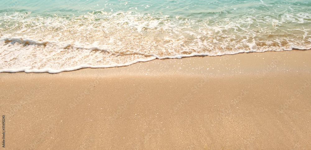 wave of blue ocean on sandy beach. texture Background.