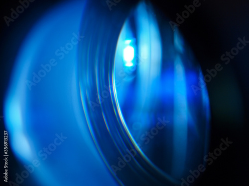 Фотография Led projector lens close up with soft focus. Blue lights.