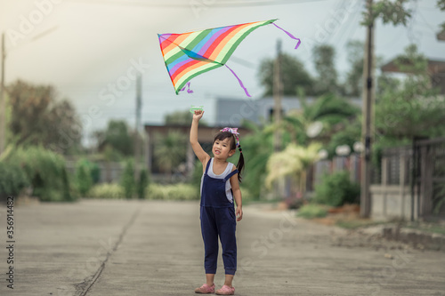 Close-up view of cute girl playing with sports (kite sport), learning outside the classroom during the summer semester and making good use of leisure time.