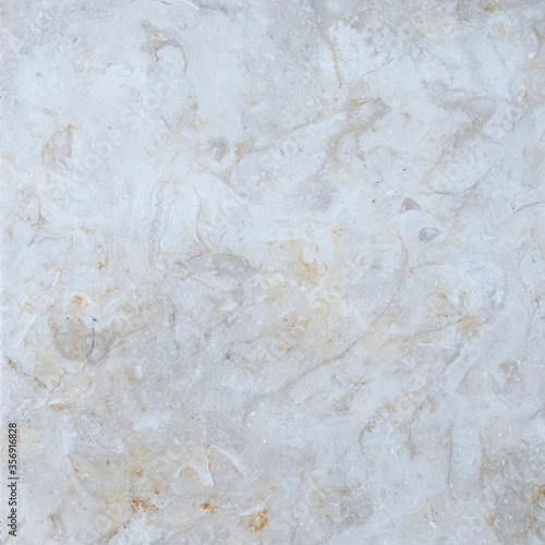Limestone tile texture with mottled pattern and golden undertone