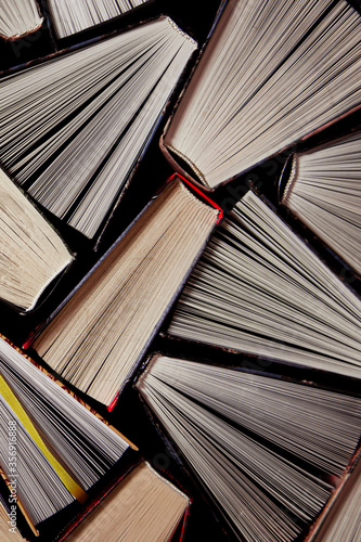 The old library. Many old multicolored books stand on the bookshelf