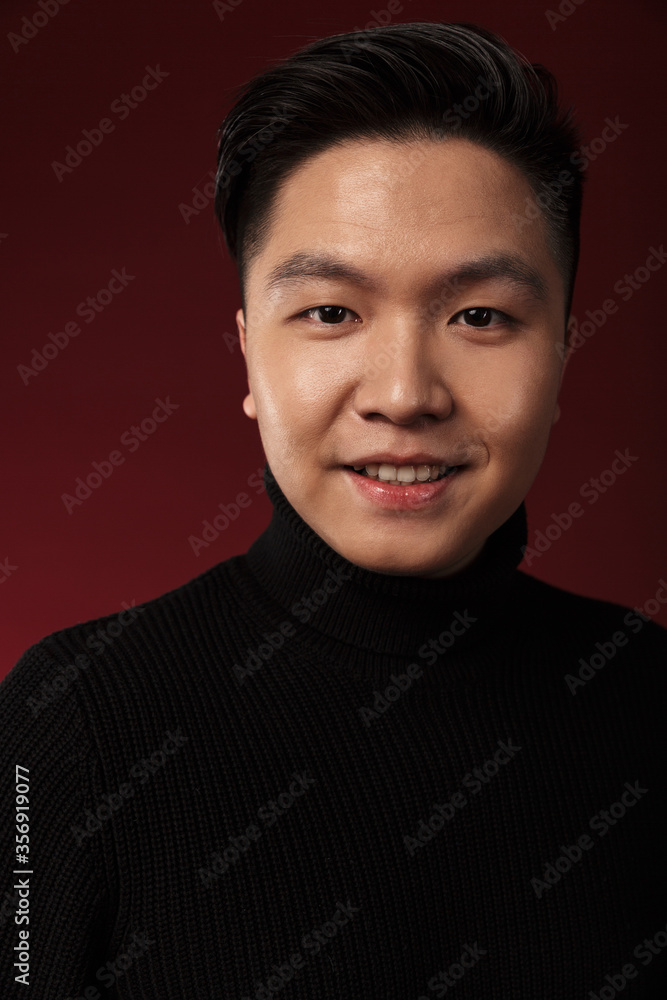 Image of cheerful asian man smiling and looking at camera Image of cheerful asian man smiling and looking at camera