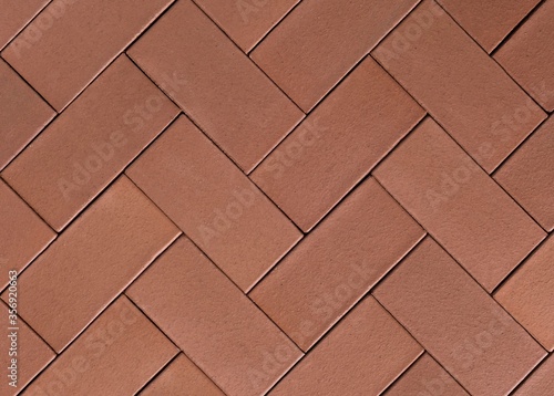 Seamless herringbone paving slabs texture in brick red