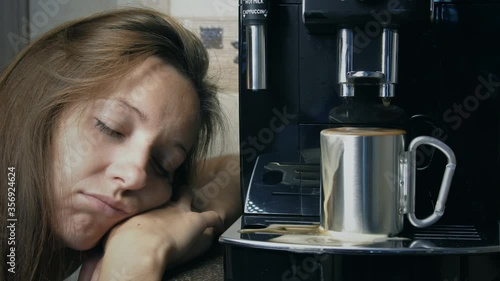 Morning coffee and a sleeping girl. Coffee machine and sleeping girl. Overflowing cup of coffee