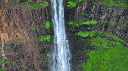 Epic revealing  aerial footage of gorgeous waterfall, Jurassic Falls, Kauai, Hawaii