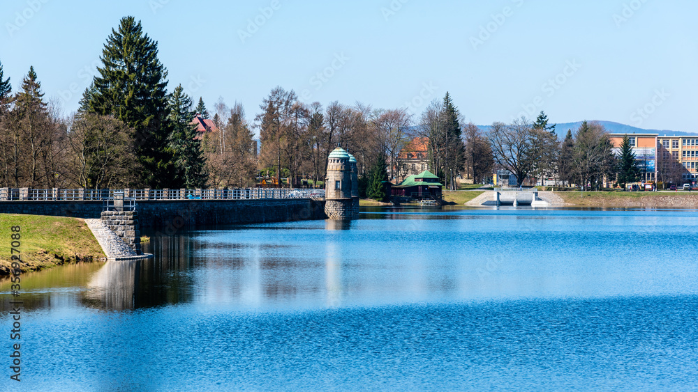 Mseno Reservoir with old stone dam on sunny day. Jablonec nad Nisou, Czech Republic