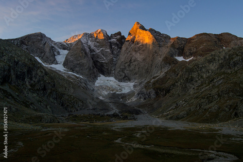North face of Vignemale mountain lighting up at sunrise, french pyrenees, France